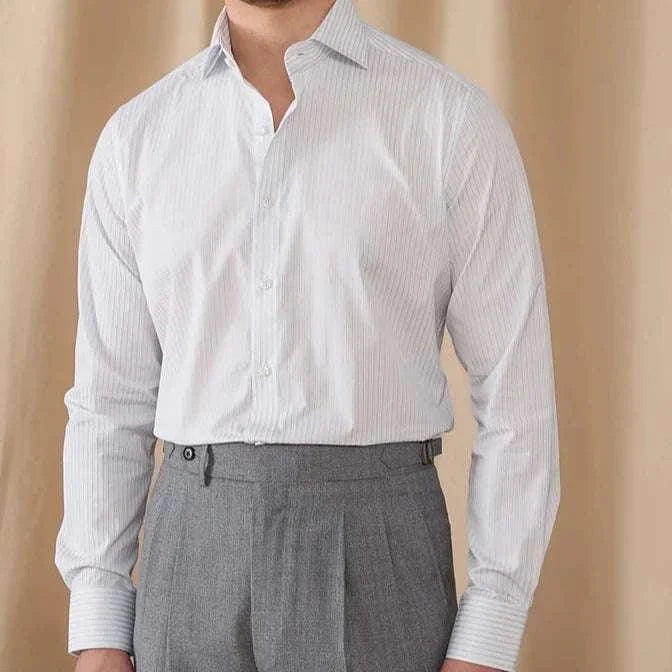 Business slim fit long sleeve premium shirt in white on man with gray trousers.