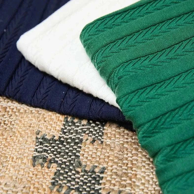 Spring gentleman English t-shirt; close-up of fabric textures in navy, white, and green, showcasing stylish, breathable material.