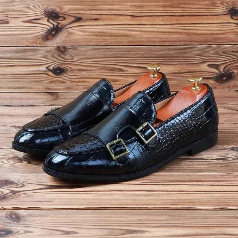 Crocodile pattern microfiber shoes in black with buckles on wooden floor.