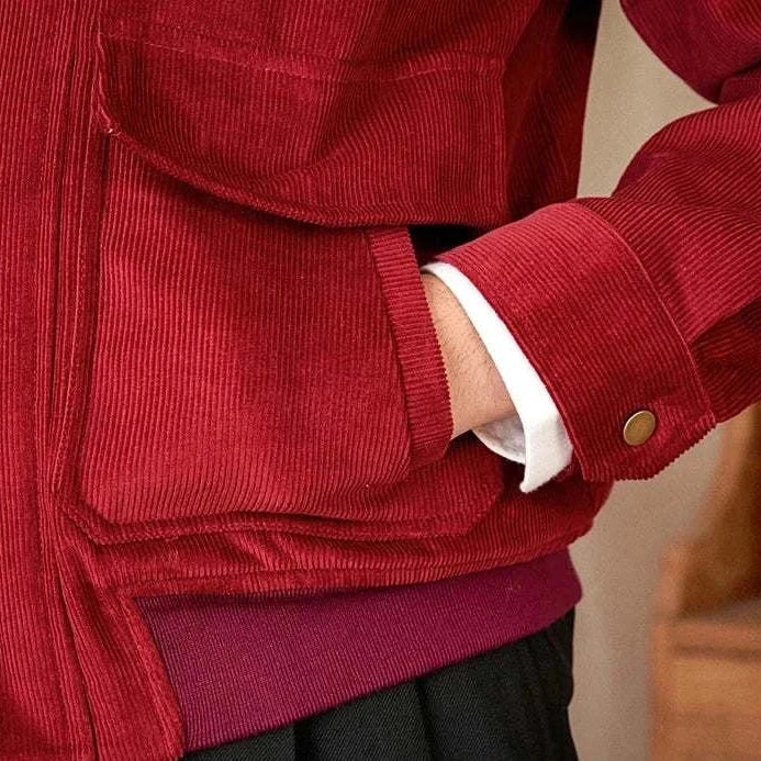 Pure cotton bomber jacket in red fabric, close-up of pocket detail.