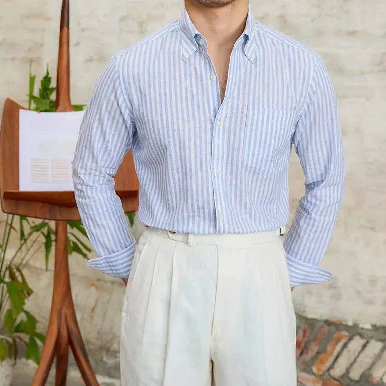 Antonios business striped long-sleeve shirt in light blue and white, shown on a model with white pants.