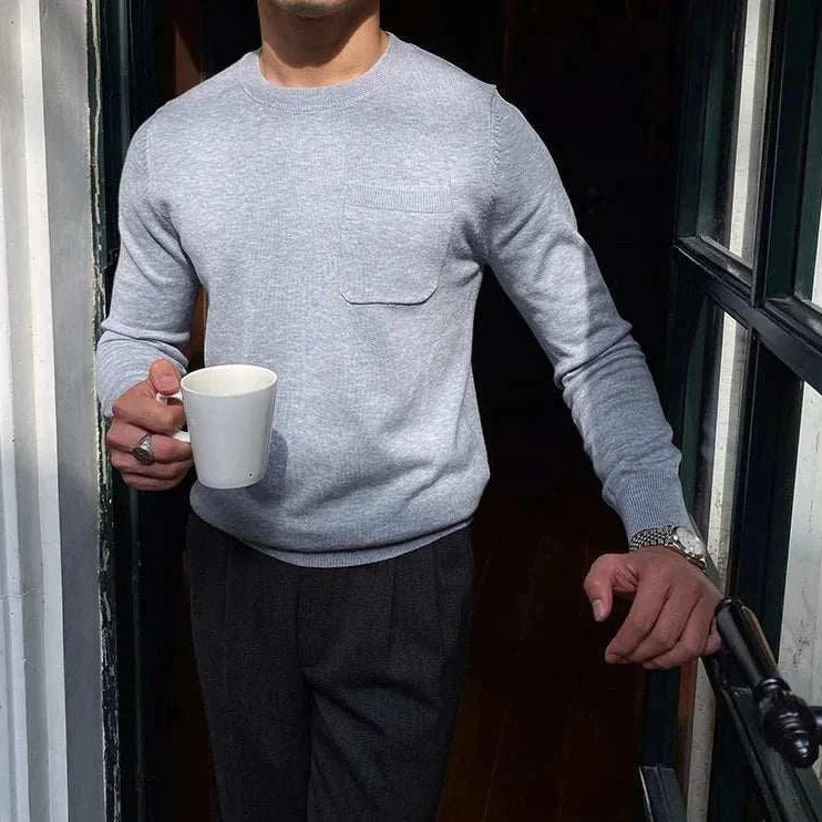 Man wearing Antonios office premium sweater, holding a mug.