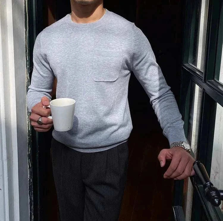 Man wearing Antonios office premium sweater, holding a mug.