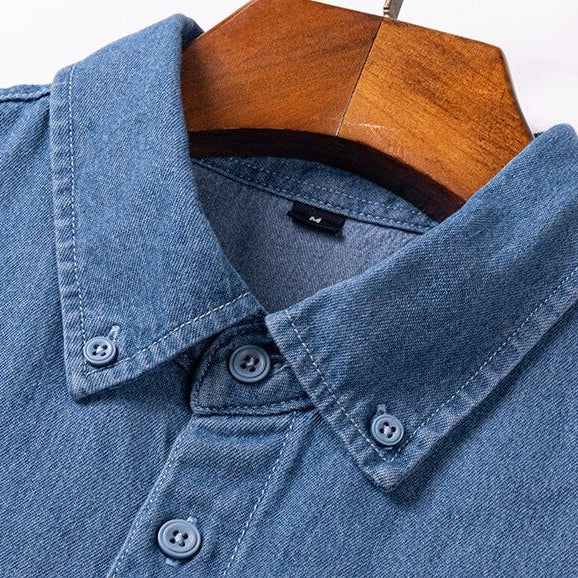 Business casual denim shirt with classic collar, crafted from soft organic cotton.