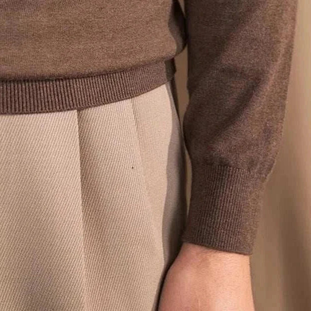 Close-up of Antonios slim fit half-turtleneck sweater in brown, paired with beige trousers.