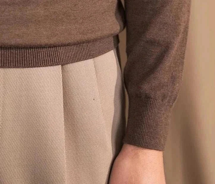 Close-up of Antonios slim fit half-turtleneck sweater in brown, paired with beige trousers.