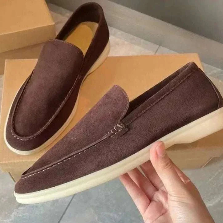 Suede elegant loafers in soft sheep leather, displayed on shoe boxes.
