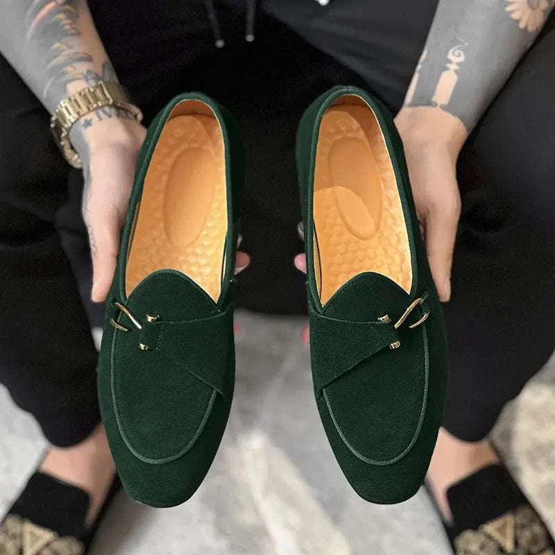Elegant green suede leather loafers for men with cushioned insoles and intricate perforations.