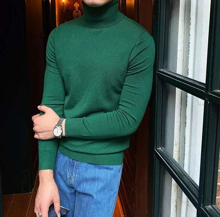 Antonios business turtleneck sweater in green paired with blue jeans.