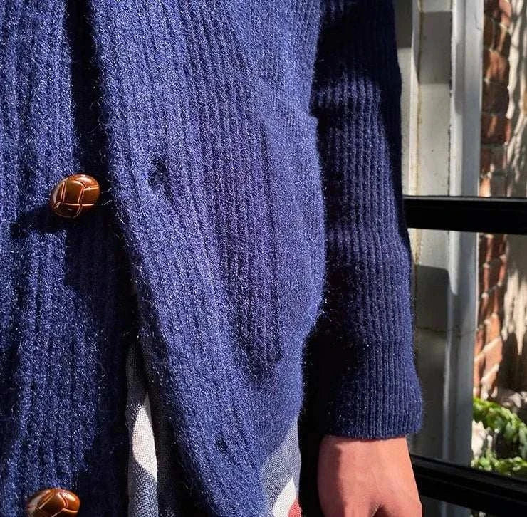 Navy Oxford premium cardigan with brown buttons, perfect for chilly weather.