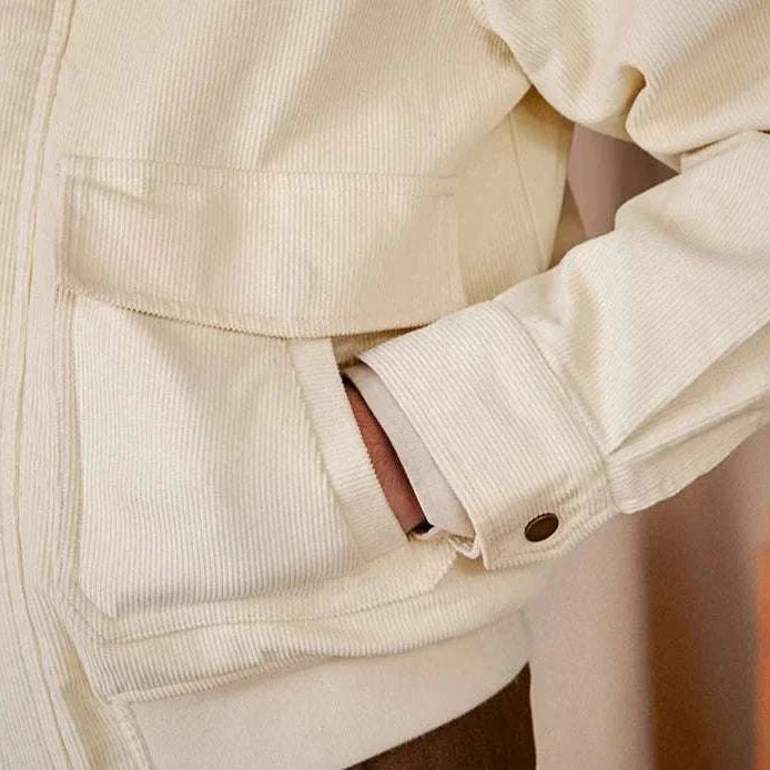 Pure cotton bomber jacket, close-up of soft, breathable fabric with pocket detail.