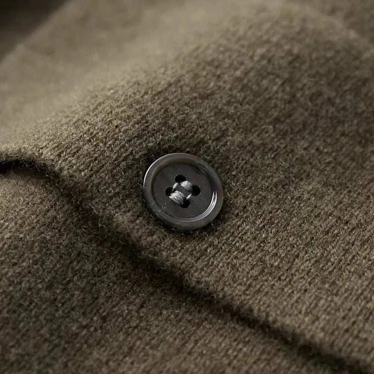 Close-up of a button on Antonios wool polo collar cardigan showing the fabric texture.
