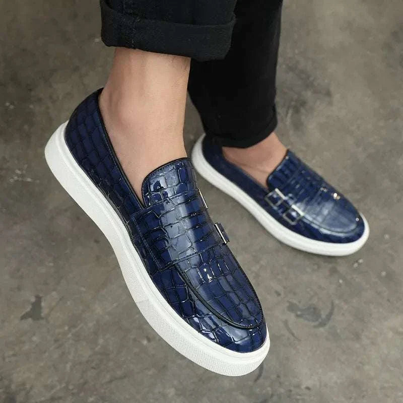Monk double strap loafers in blue suede with white PU leather outsole, worn by a model on a concrete floor.