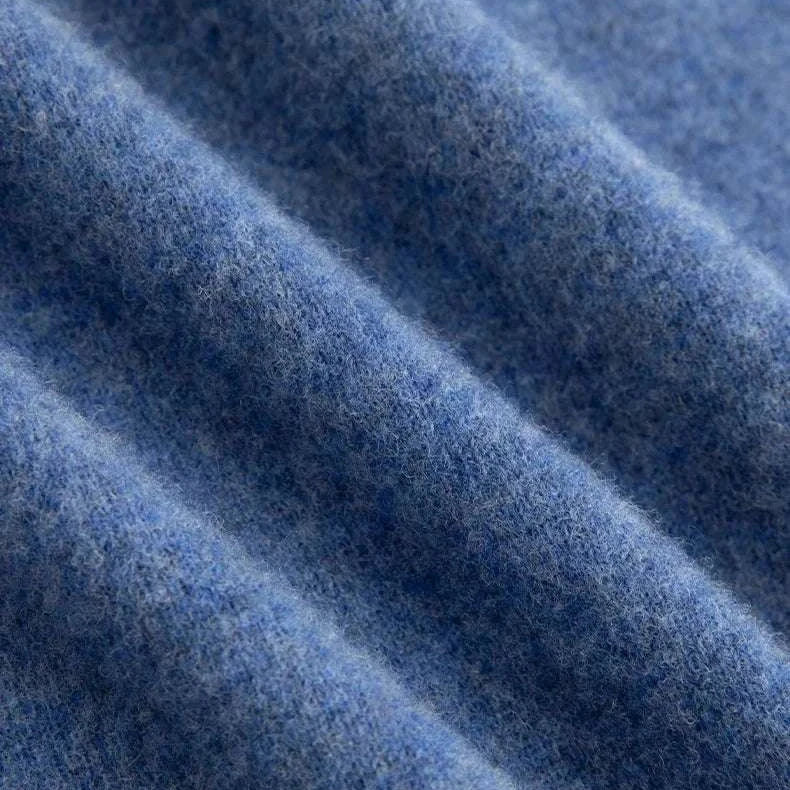 Close-up texture of a blue business wool turtleneck sweater.
