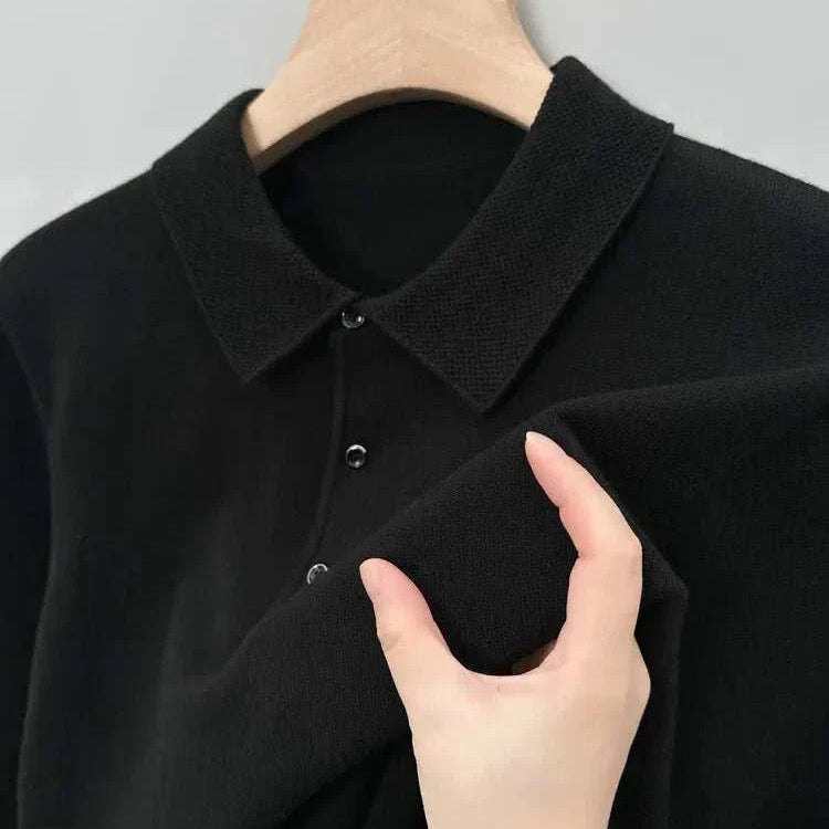 Antonios polo sweater with buttons in black on hanger.