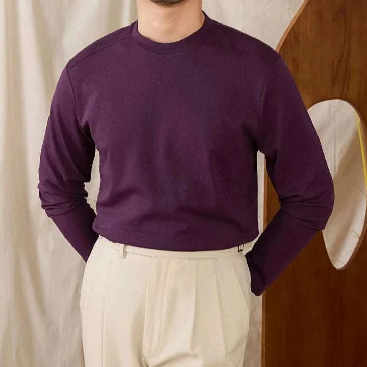 Slim fit smart casual premium sweater in deep plum, worn with beige pants.