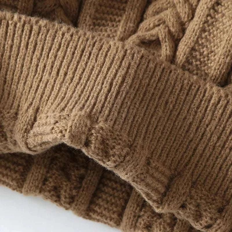 Close-up of khaki Juku winter sweater showing fine knitted texture.