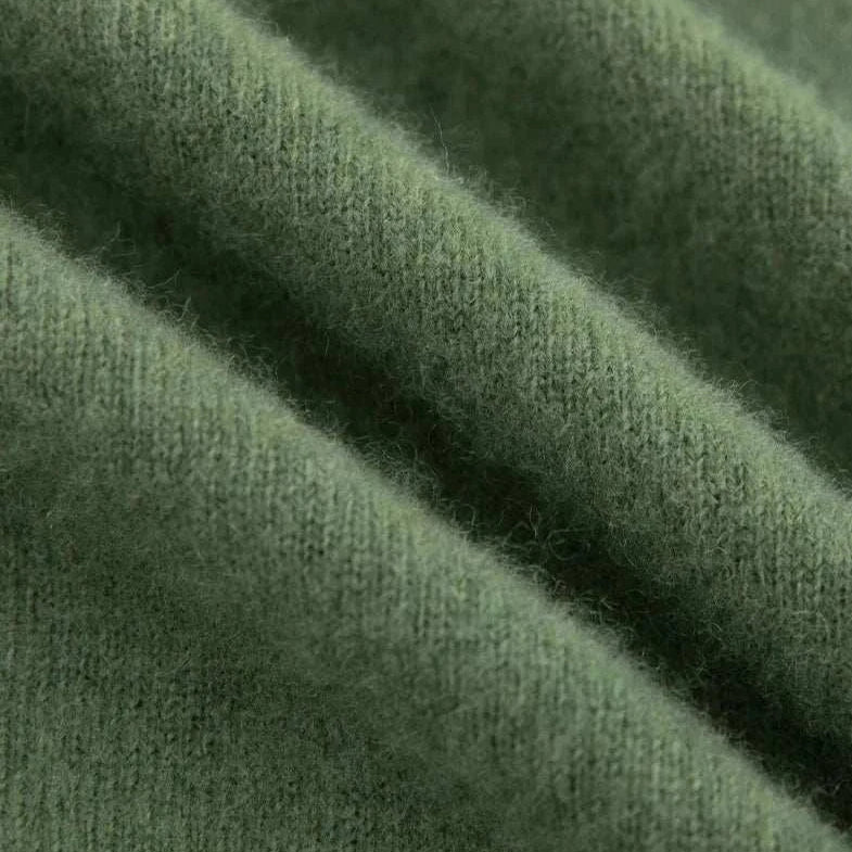 Close-up of green wool fabric for business turtleneck sweater.