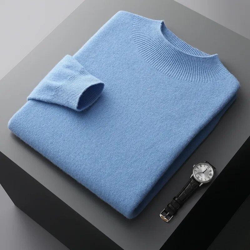 Sky blue Antonios Pure Wool Sweater neatly folded, showcasing premium quality material, next to a stylish watch.