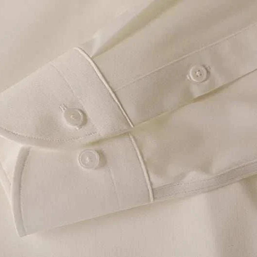 Close-up of Antonios washed tuxedo shirt sleeve, showcasing stylish office wear design.