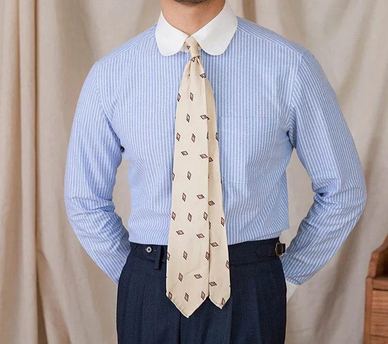 Antonios striped cotton business shirt in blue with white collar, worn with a patterned tie.