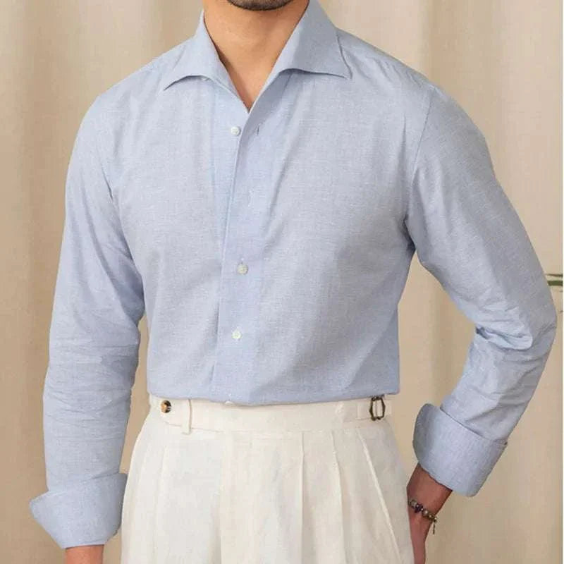Men's piece collar casual long-sleeve shirt in light blue, worn with white trousers.