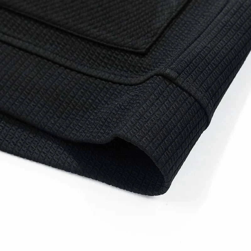 Close-up of a black winter cardigan sweater with zipper, showcasing cozy polyester-spandex fabric texture.