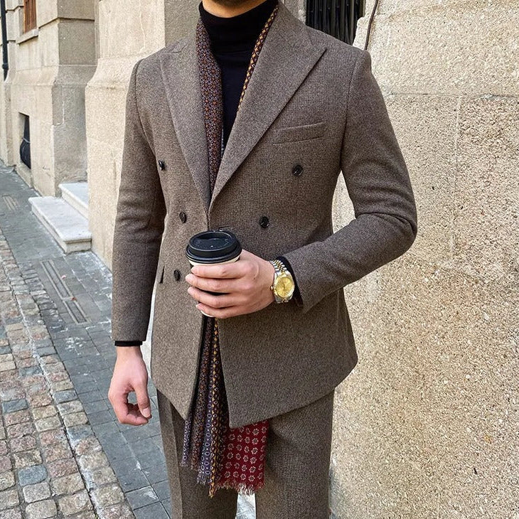 Man wearing an office double-breasted suit in elegant brown fabric, holding a coffee cup.