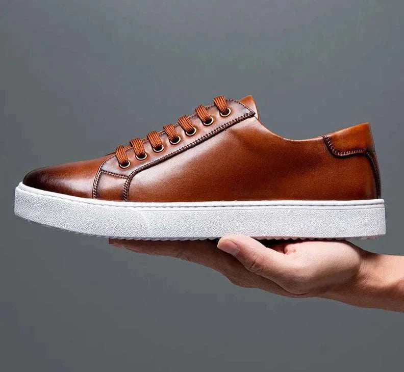 Brown LUXELY office leather shoes with white sole on display.