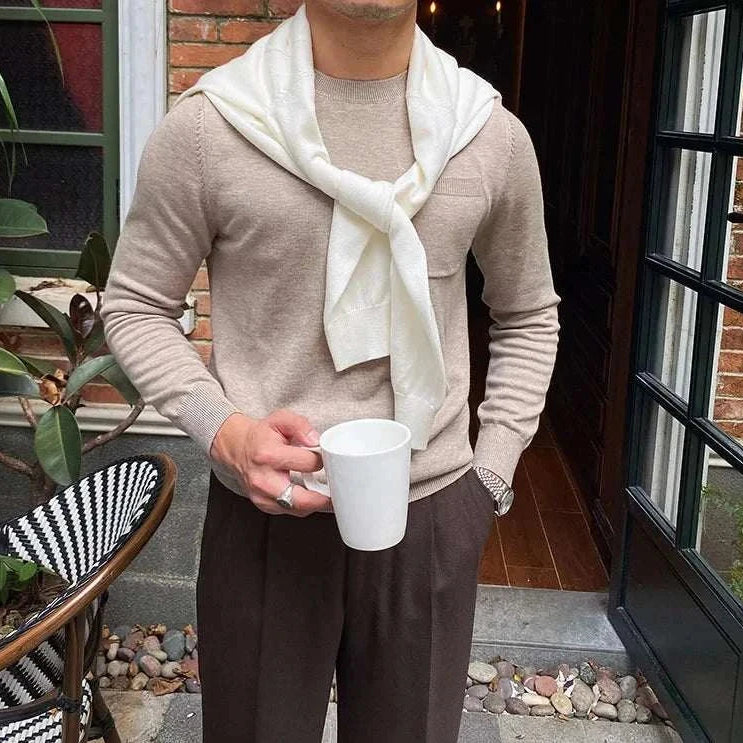 Man wearing Antonios office premium sweater holding a mug outdoors.