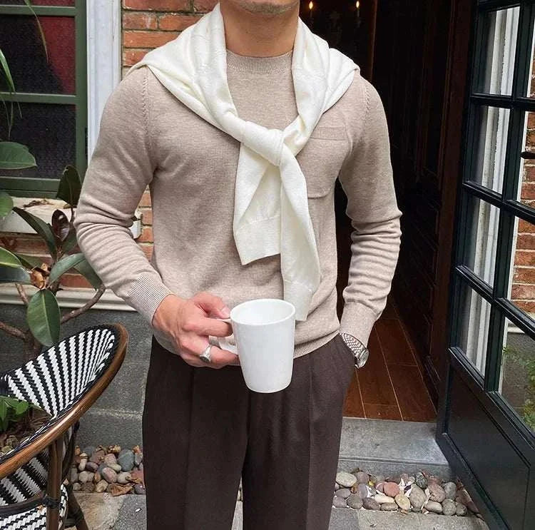 Man wearing Antonios office premium sweater holding a mug outdoors.