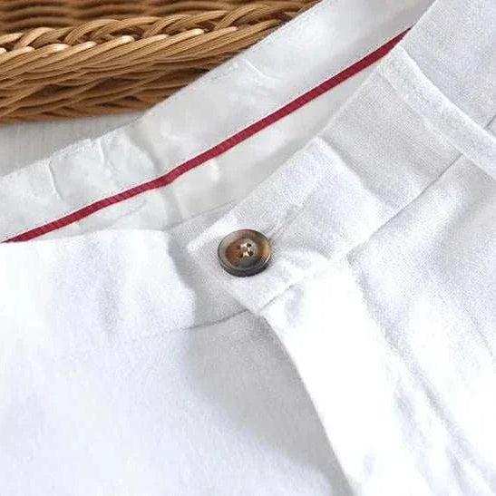 White linen straight oversize trousers with button detail.