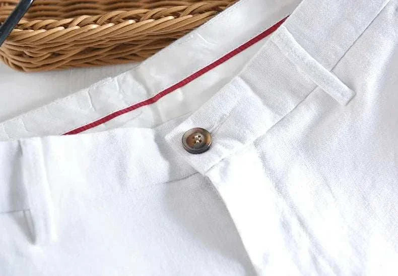 White linen straight oversize trousers with button detail.