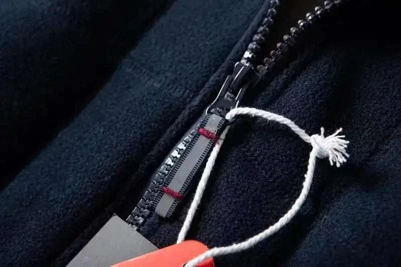 Close-up of zipper on a Norway puffer jacket in black fabric.