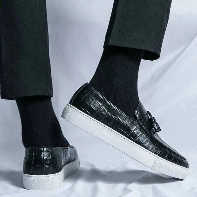 Casual slip-on loafers in black suede with elastic side panels and white sole.