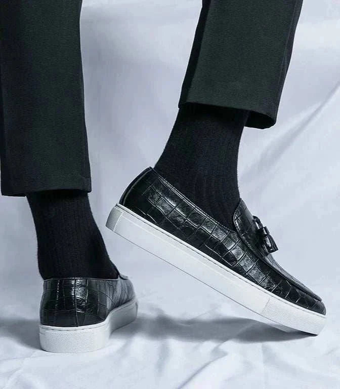 Casual slip-on loafers in black suede with elastic side panels and white sole.