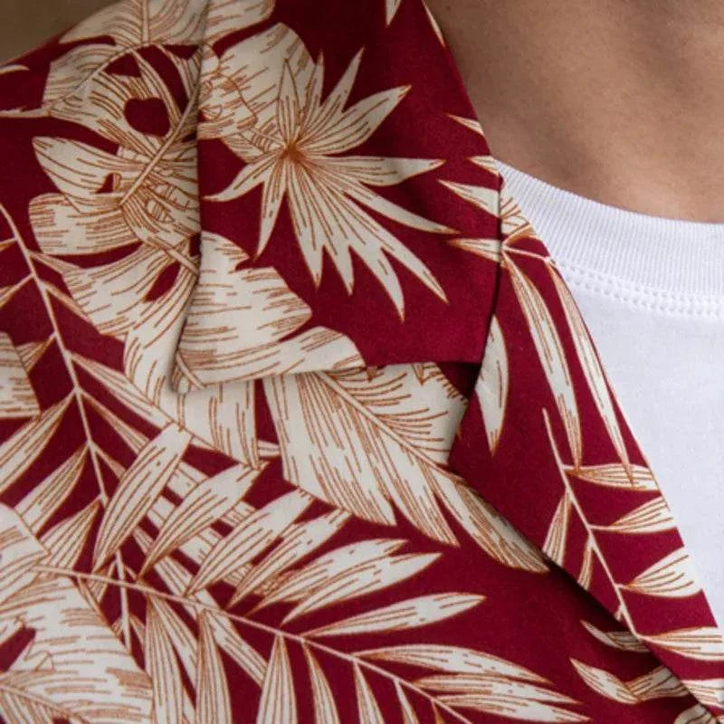 Close-up of a vintage Hawaiian flower shirt with a red and beige floral pattern.