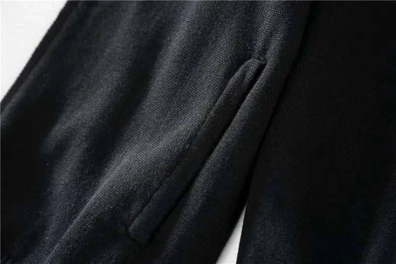 Cold season casual cardigan in black cotton fabric, close-up view.