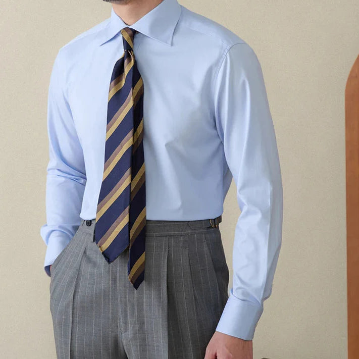 Italian style old money shirt with striped tie and gray pants.