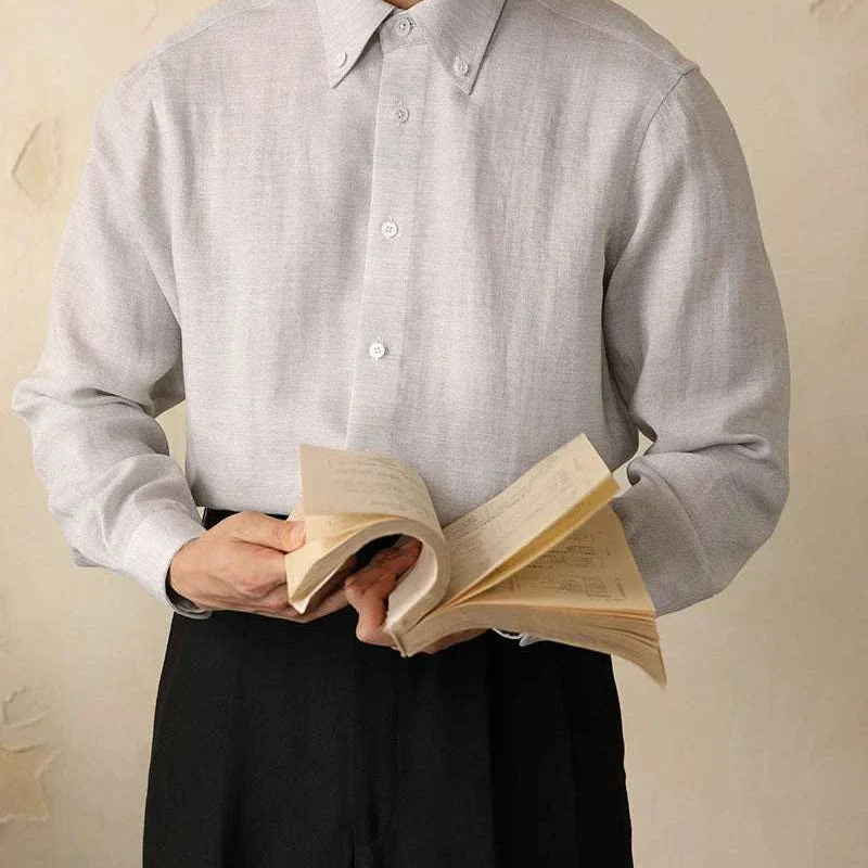 Antonios one-piece collar cotton shirt in high-quality cotton and viscose, worn by a man holding a book.