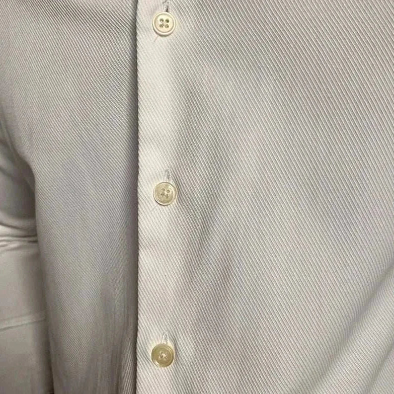 Business collar long sleeve shirt in solid light color with button details, suitable for casual and office wear.