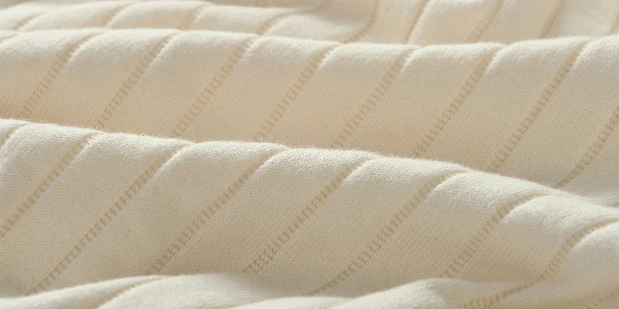 Close-up of soft, textured cotton fabric in cream, showcasing the material of a vintage business cotton summer t-shirt.