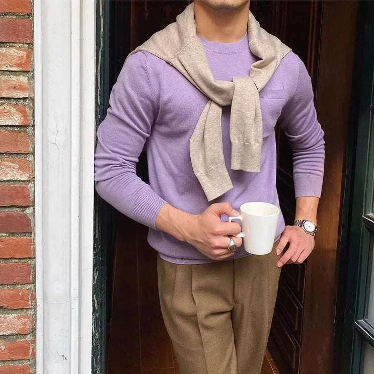 Man wearing Antonios office premium sweater holding a coffee mug.