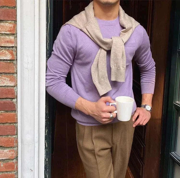 Man wearing Antonios office premium sweater holding a coffee mug.