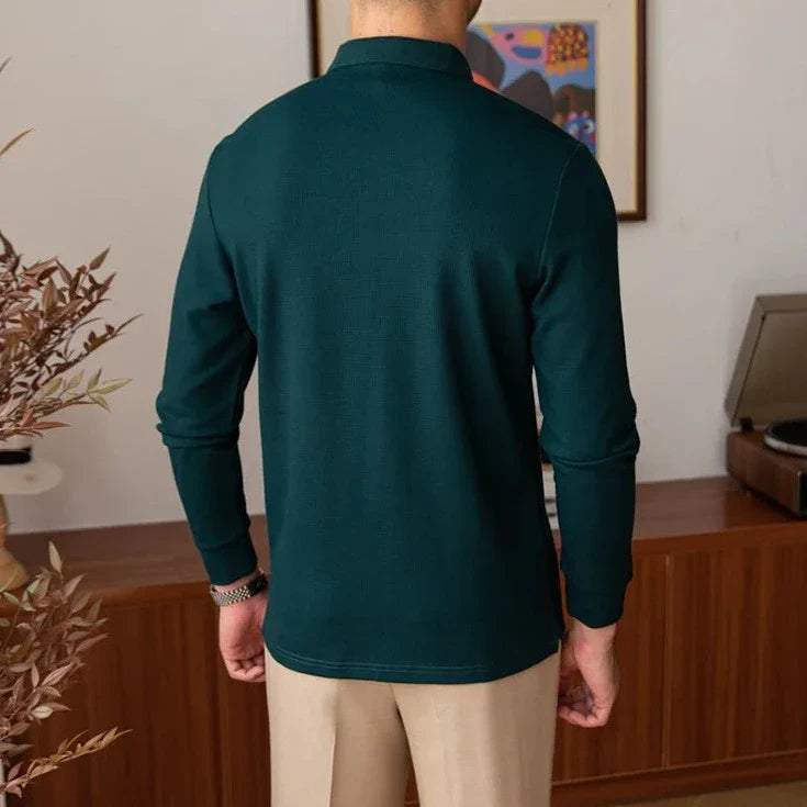 Man wearing a heavy premium sweater in dark green, 100% cotton, designed for warmth.