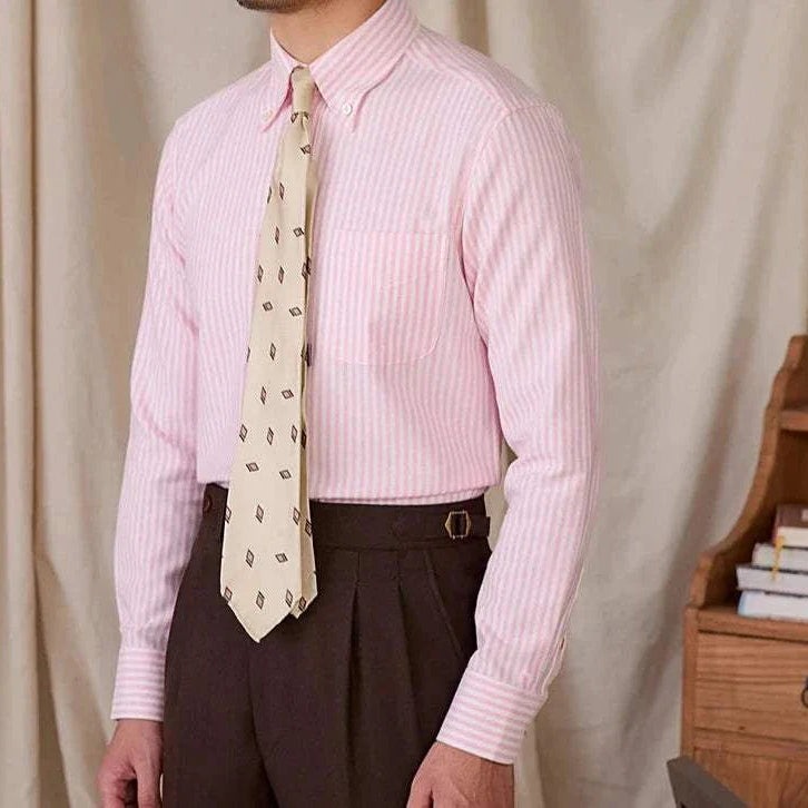 Men's pink Oxford style casual cotton shirt with white stripes and a beige patterned tie.