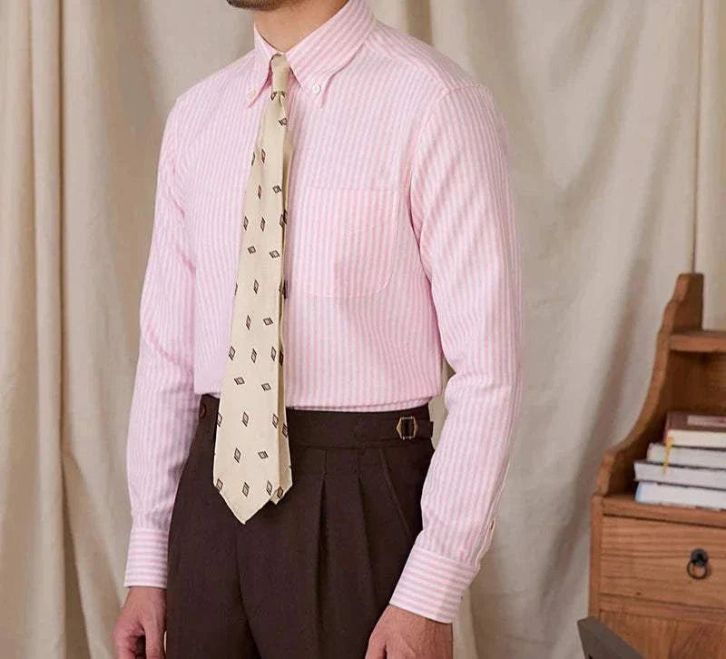 Men's pink Oxford style casual cotton shirt with white stripes and a beige patterned tie.