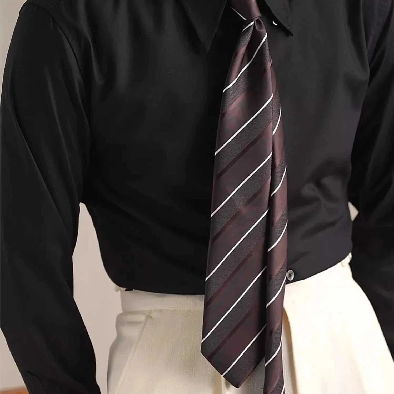 Party tuxedo long sleeve shirt in black with striped tie.