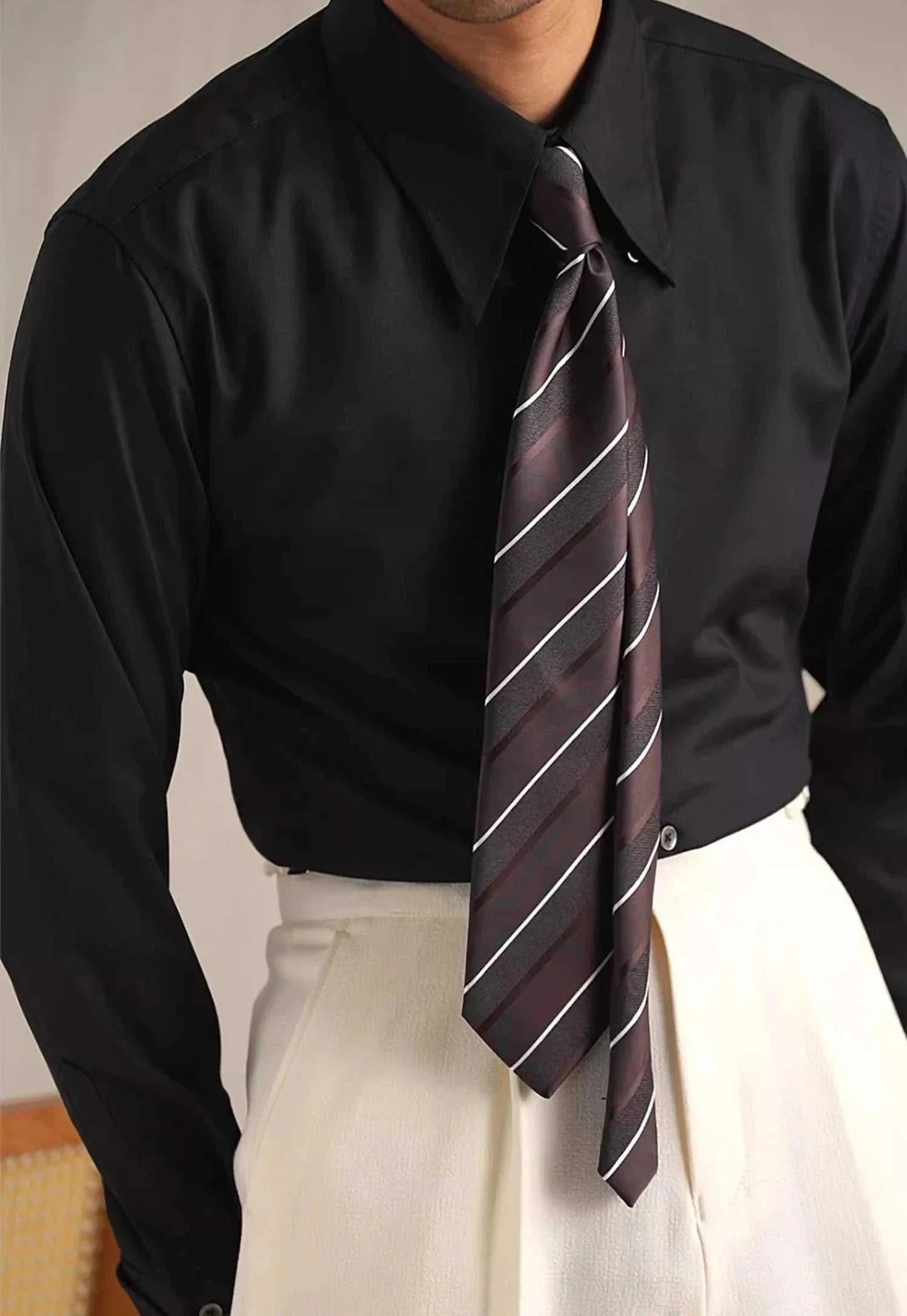 Party tuxedo long sleeve shirt in black with striped tie.