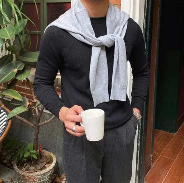 Man wearing Antonios office premium sweater holding a coffee mug.